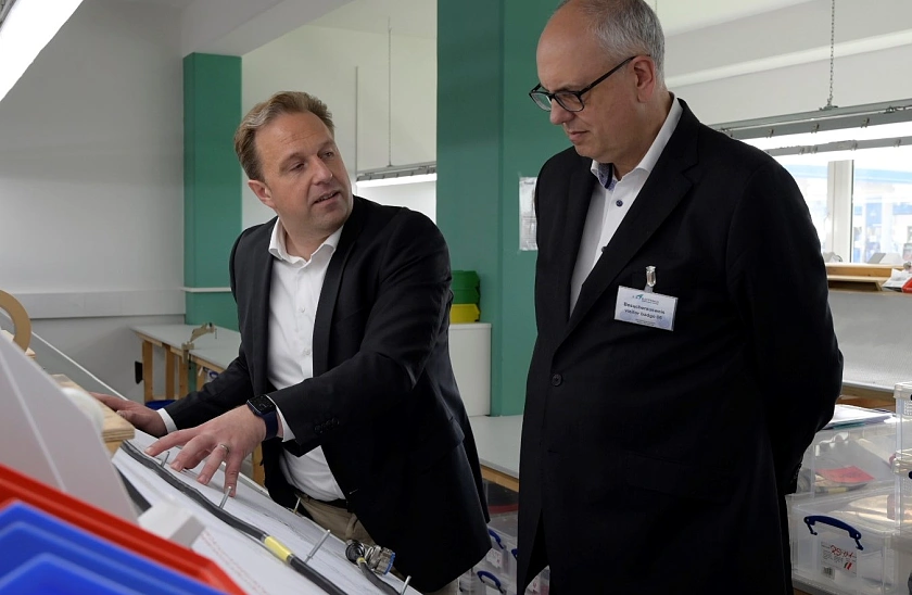 E.I.S.-Geschäftsführer Cezary Pilarski (links) erläutert Bürgermeister Bovenschulte den Bau von Kabelbäumen.